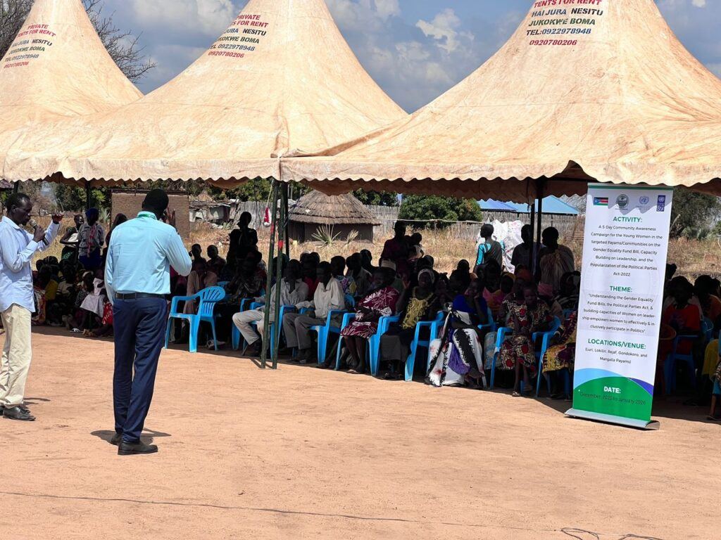 2 men presenting to the community audience about the activity under a large tent.